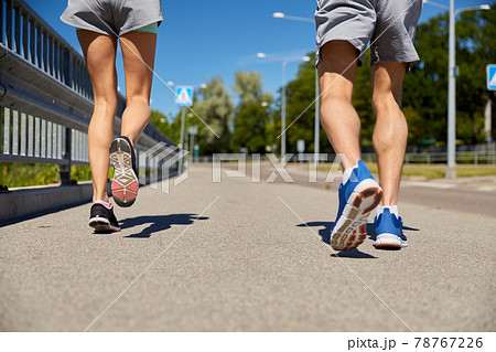 feet of sporty couple running along city road feet of sporty couple running along city road 78767226