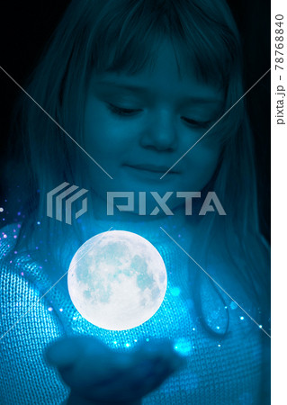 Little girl holding the moon and stars on the palm of her hand 78768840