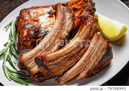 grilled pork ribs with lemon and rosemary 78768943