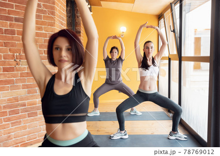 Group of young women in the gym centre. Yoga. 78769012