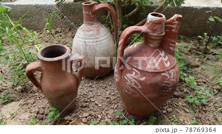Big clay pot or jug standing on the dirty land in Cappadocia, Turkey Big clay pot or jug standing on the dirty land in Cappadocia, Turkey 78769364