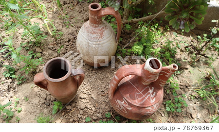 Big clay pot or jug standing on the dirty land in Cappadocia, Turkey 78769367