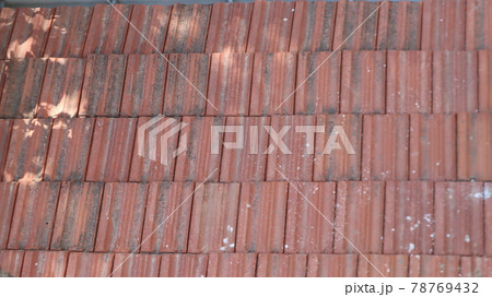 Orange color tile roof background. Close-up of the red clay texture of a house rooftop 78769432