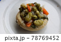Healthy food Artichoke on the white plate. Close-up Artichoke food with beans, peas, onions and carrots. Delicious healthy vegan food with olive oil. 78769452