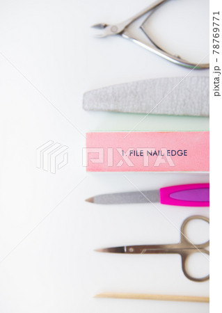 Manicure tools set on a white background. File, buff, scissors, orange stick. Buff with nail file inscription. Manicure tools set on a white background. File, buff, scissors, orange stick. Buff with nail file inscription. 78769771