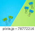 Multicolored paperclip on blue green background 78772216