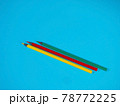Yellow, Green and Red Pencils on Blue Background 78772225