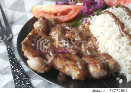 detail shot of grill chicken , rice and salad on plate on table  78772668