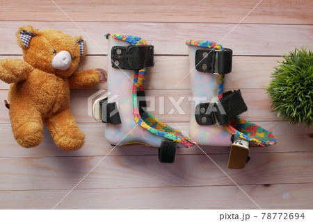 Child cerebral palsy disability shoes on table Child cerebral palsy disability shoes on table 78772694