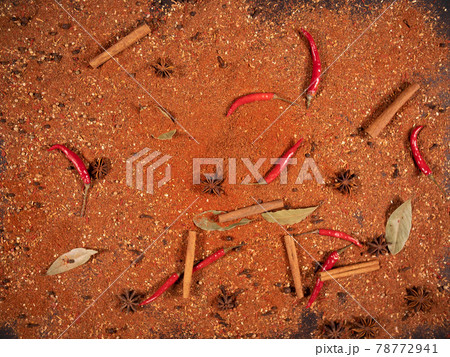 Top view of spicy red capsicum cinnamon and ground pepper lie on the table. Spicy food concept and oriental cuisine 78772941