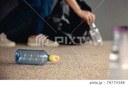 Environment, Ecology Care, Renewable Concept. Volunteer Collecting Plastic Bottle Waste on Public Floor to Trash. Keep City Clean. Close Up and Selective Focus Environment, Ecology Care, Renewable Concept. Volunteer Collecting Plastic Bottle Waste on Public Floor to Trash. Keep City Clean. Close Up and Selective Focus 78774386