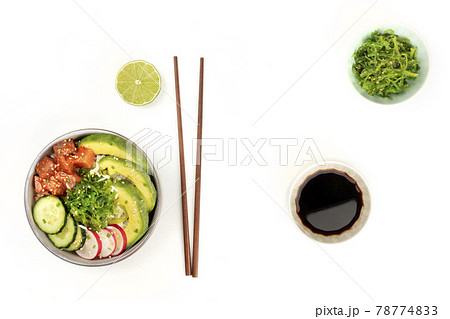 Hawaiian tuna poke salad on white, with wakame seaweed salad, chopsticks, and copy space Hawaiian tuna poke salad on white, with wakame seaweed salad, chopsticks, and copy space 78774833