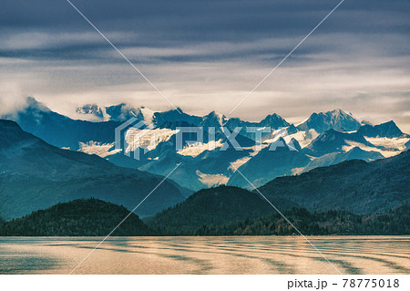 Alaska mountains range snow capped peaks in inside passage, Glacier bay nature landscape at autumn sunset dusk. View from cruise ship travel. 78775018