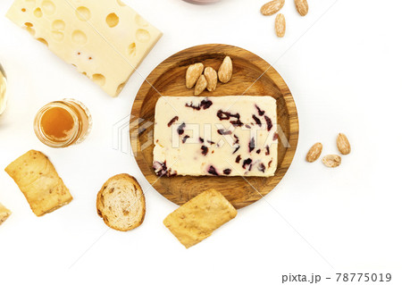 Overhead photo of cheese with cranberries on white 78775019