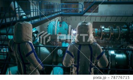 Scientists watch the work of a time machine or a futuristic thermonuclear reactor. A physicist controls a time machine. 3D Rendering. Scientists watch the work of a time machine or a futuristic thermonuclear reactor. A physicist controls a time machine. 3D Rendering. 78776715