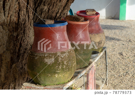Clay jugs filled with water to drink or wash for hikers and visitors in a village in Sudan. 78779373