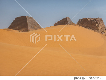 Pyramids behind a large sand dune in the desert of Sudan 78779426