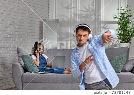 daughter learns using laptop and playful happy father dancing daughter learns using laptop and playful happy father dancing 78781248