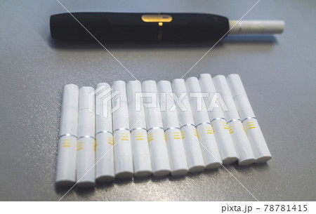 Tobacco heating system and a pack of tobacco sticks on a gray background 78781415