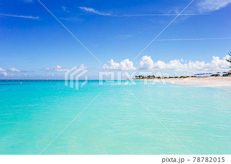 Idyllic tropical beach in Caribbean with white sand, turquoise ocean water and blue sky Idyllic tropical beach in Caribbean with white sand, turquoise ocean water and blue sky 78782015