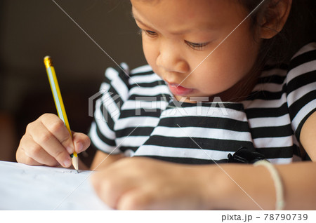 Close-up of children who are serious about writing books and homework. Close-up of children who are serious about writing books and homework. 78790739