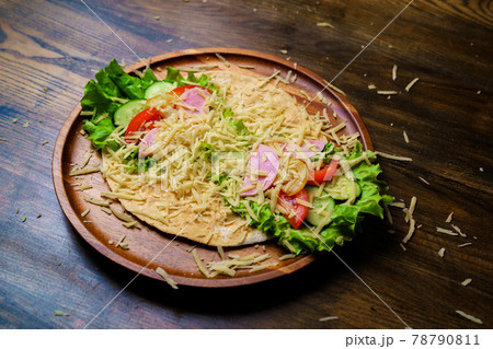 pita with vegetables, sausage and cheese.simple and delicious snack of flatbread 78790811
