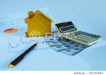 Finance saving for house, piggy bank with calculator on pile of banknotes. 78793985