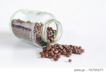 Coffee beans in glass bottles on white background. 78795077