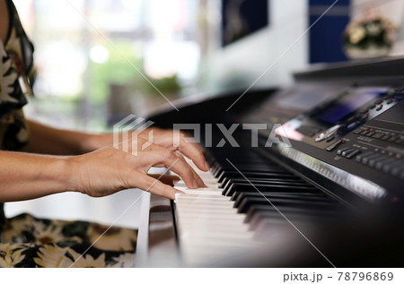 Close-up hand playing piano keyboard for relaxation time and stay at home 78796869