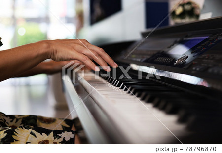 Close-up hand playing piano keyboard for relaxation time and stay at home 78796870