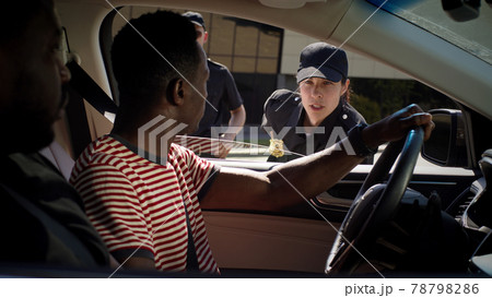Black men discussing police officer in vehicle 78798286
