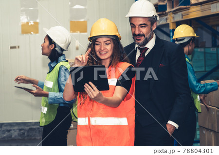 Warehouse senior manager discuss with worker in the storehouse Warehouse senior manager discuss with worker in the storehouse 78804301