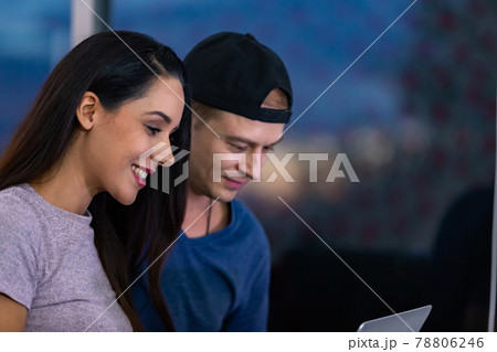 Young couple relaxing and enjoying at home on sofa with laptop. Young couple relaxing and enjoying at home on sofa with laptop. 78806246