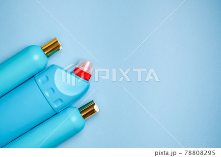 Blank blue plastic bottles in the left part background. Household chemistry, shampoo, cleaner. Blank blue plastic bottles in the left part background. Household chemistry, shampoo, cleaner. 78808295