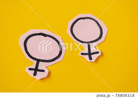 Two gender symbols Venus cut from pink paper on yellow background. Concept lgbt. 78808318