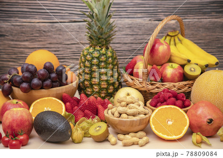 Group Fruits mixed with banana, orange, strawberry and nuts, concept health food and diet, vegetarian food in the top view on the wood table. 78809084