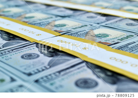 Many wads of one hundred dollar bills in a bank package. 78809125