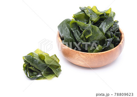 Fresh seaweed wakame in wooden bowl isolated on white background. Japanese food Fresh seaweed wakame in wooden bowl isolated on white background. Japanese food 78809623