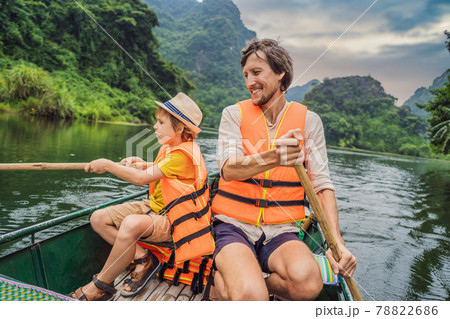 Happy family tourists in Trang An Scenic Landscape Complex in Ninh Binh Province, Vietnam A UNESCO World Heritage Site. Resumption of tourism in Vietnam after quarantine Coronovirus COVID 19 78822686
