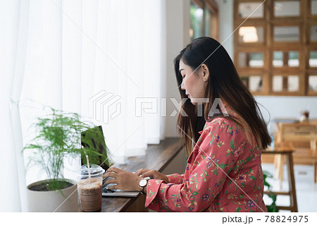Female graphic designer artist using laptop working in windowsill at the cafe Female graphic designer artist using laptop working in windowsill at the cafe 78824975