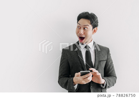 Wow and surprised face of businessman use trade application on the phone. Wow and surprised face of businessman use trade application on the phone. 78826750