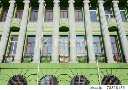 Restored old multi-storey building with antique columns, painted in green Restored old multi-storey building with antique columns, painted in green 78828186