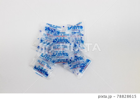 Desiccant silica on the pack. Closeup view. packet of silica gel buried in silica crystals. Desiccant silica on the pack. Closeup view. packet of silica gel buried in silica crystals. 78828615