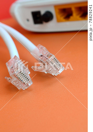 Internet router and Internet cable plugs lie on a bright orange background. Items required for Internet connection Internet router and Internet cable plugs lie on a bright orange background. Items required for Internet connection 78829241