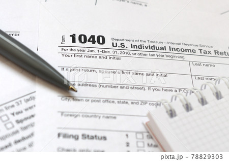 The pen and notebook is lies on the tax form 1040 U.S. Individual Income Tax Return. The time to pay taxes The pen and notebook is lies on the tax form 1040 U.S. Individual Income Tax Return. The time to pay taxes 78829303
