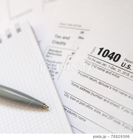 The pen and notebook is lies on the tax form 1040 U.S. Individual Income Tax Return. The time to pay taxes The pen and notebook is lies on the tax form 1040 U.S. Individual Income Tax Return. The time to pay taxes 78829306