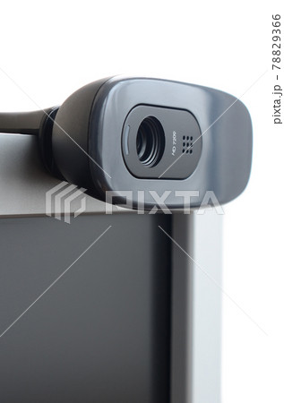A modern web camera is installed on the body of a flat screen monitor. Device for video communication and recording of high quality video 78829366