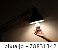 man is changing the reading lamp 78831342
