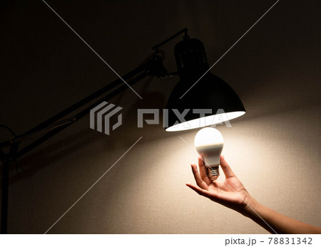 man is changing the reading lamp man is changing the reading lamp 78831342