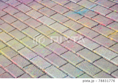 Multi colored paving slabs, powder coated with dry colors at the Holi festival 78831776